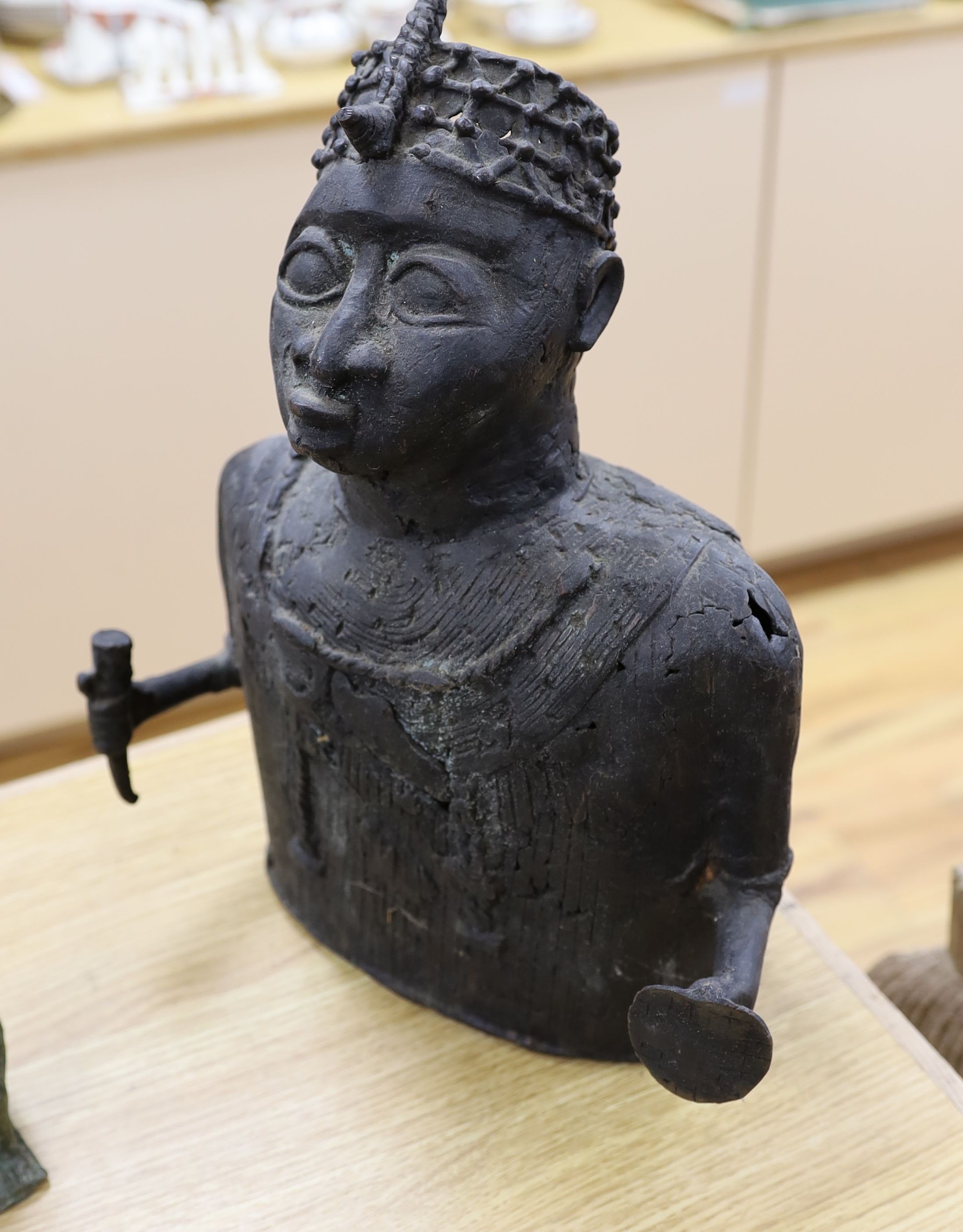 A group of Nigerian cast metal figures, bangles and a dish, tallest 36 cms high.